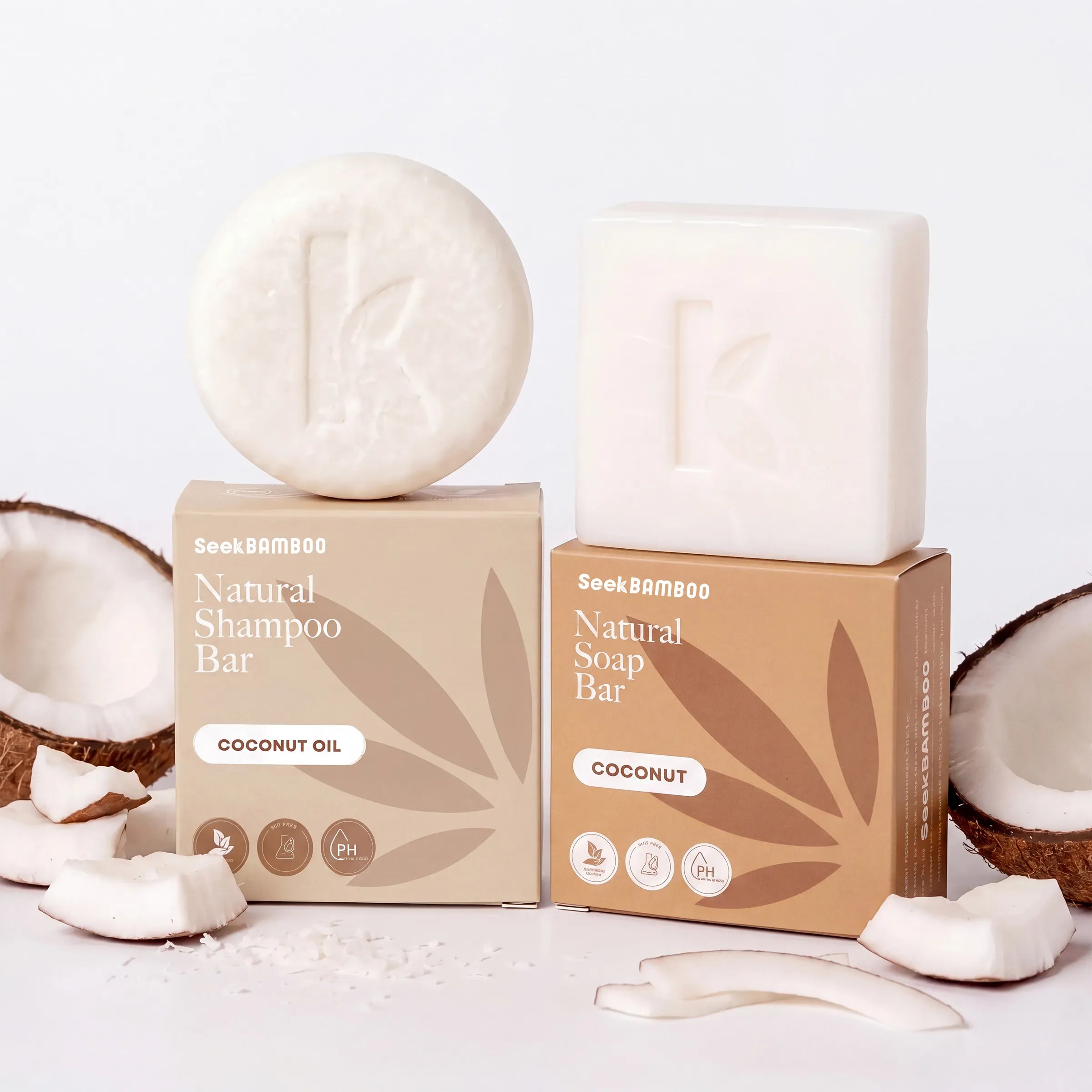 Two boxes of SeekBAMBOO Natural Soap Bar, one with Coconut Oil and one with Coconut, each showing a white soap bar on top, styled with coconut halves and cream on a white background.