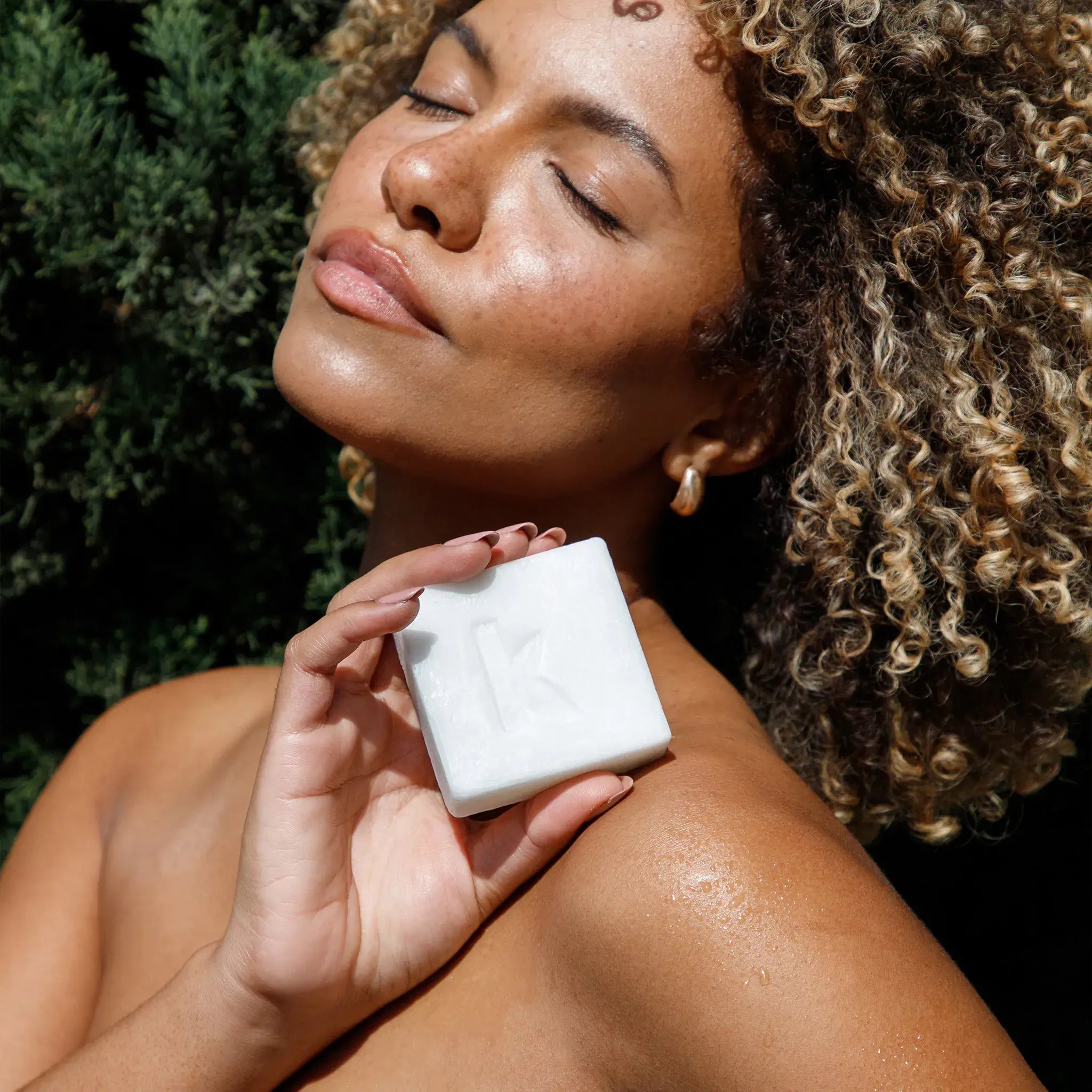 woman holding goat soap