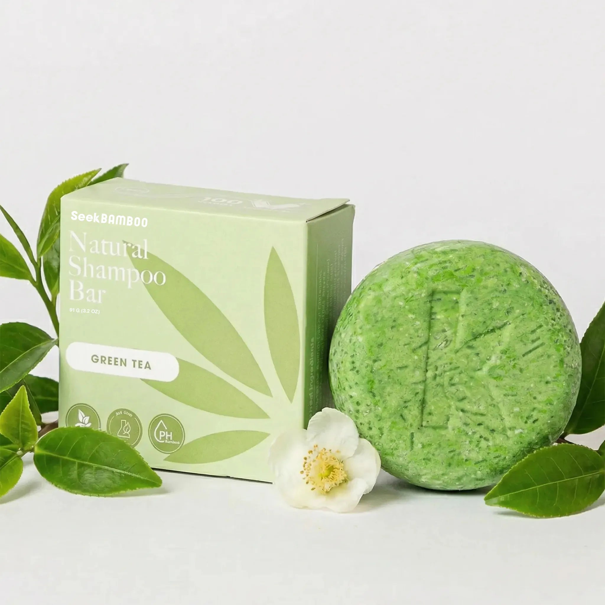 Green tea natural shampoo bar with packaging on a white background