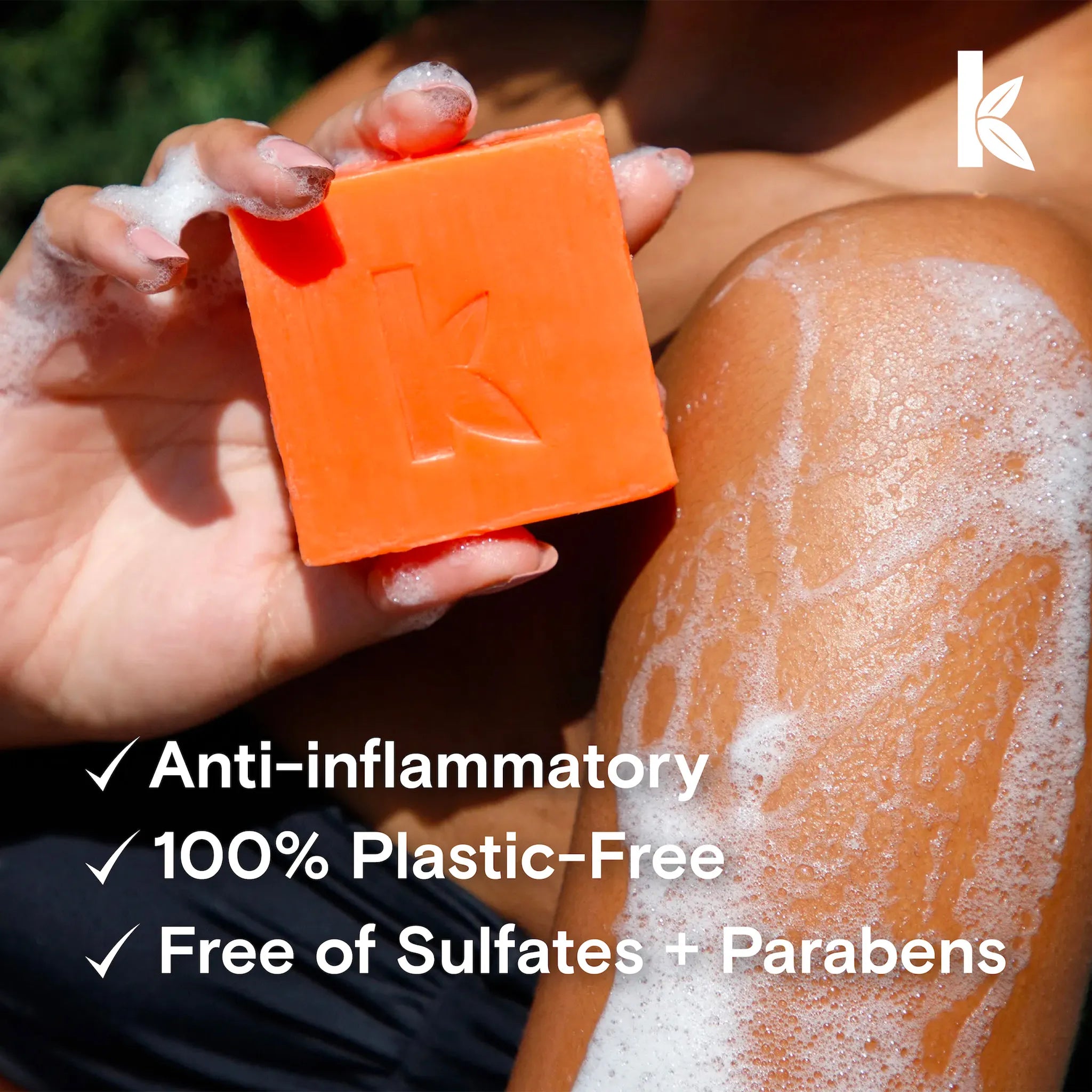 Person applying soap to their skin with an orange bar of soap, featuring Seek Bamboo logo.