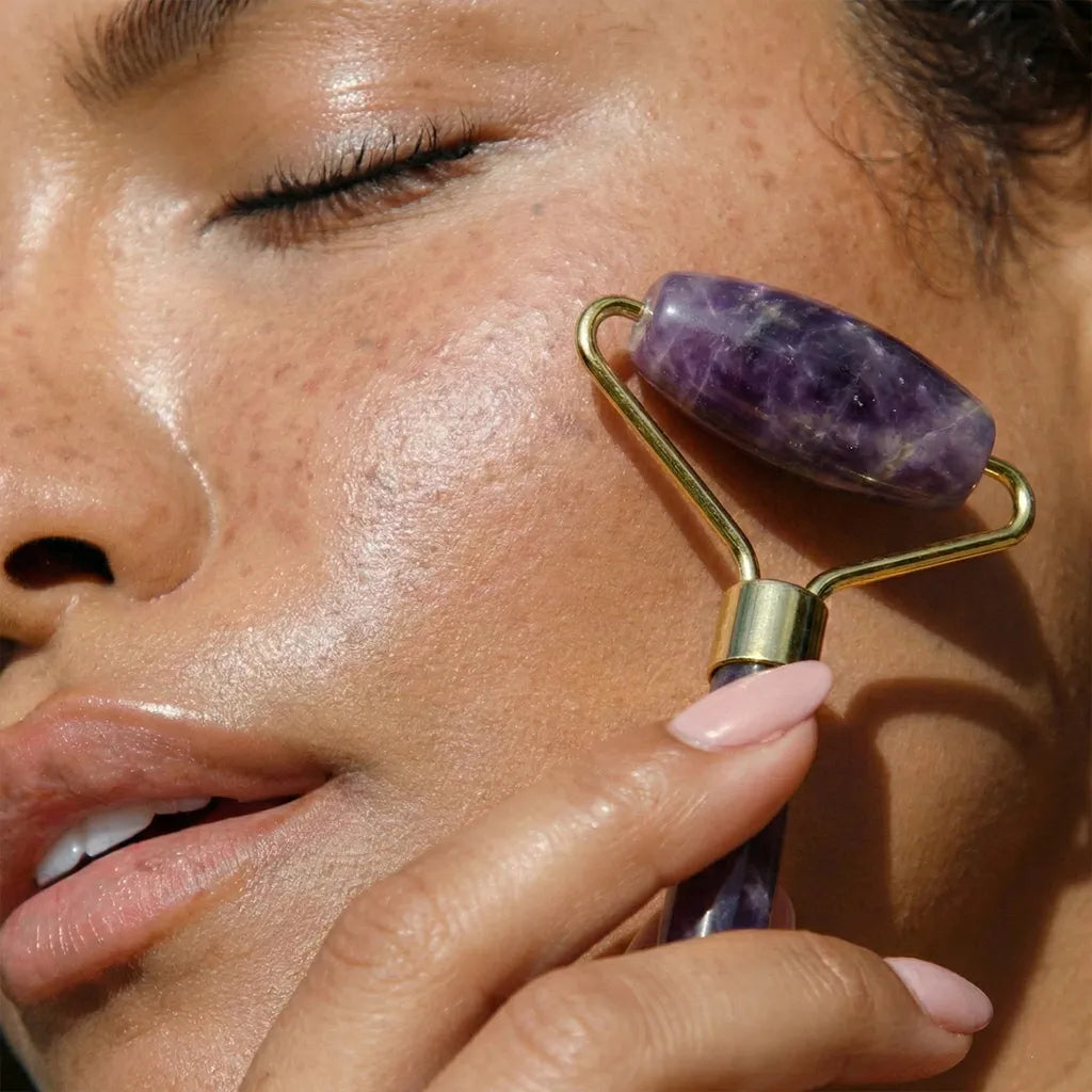 Natural Amethyst Roller used on cheeck of woman