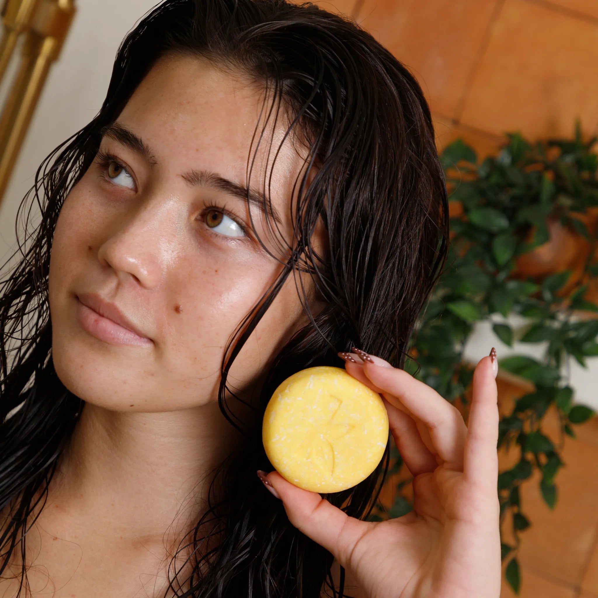 Natural Turmeric Shampoo Held In Shower