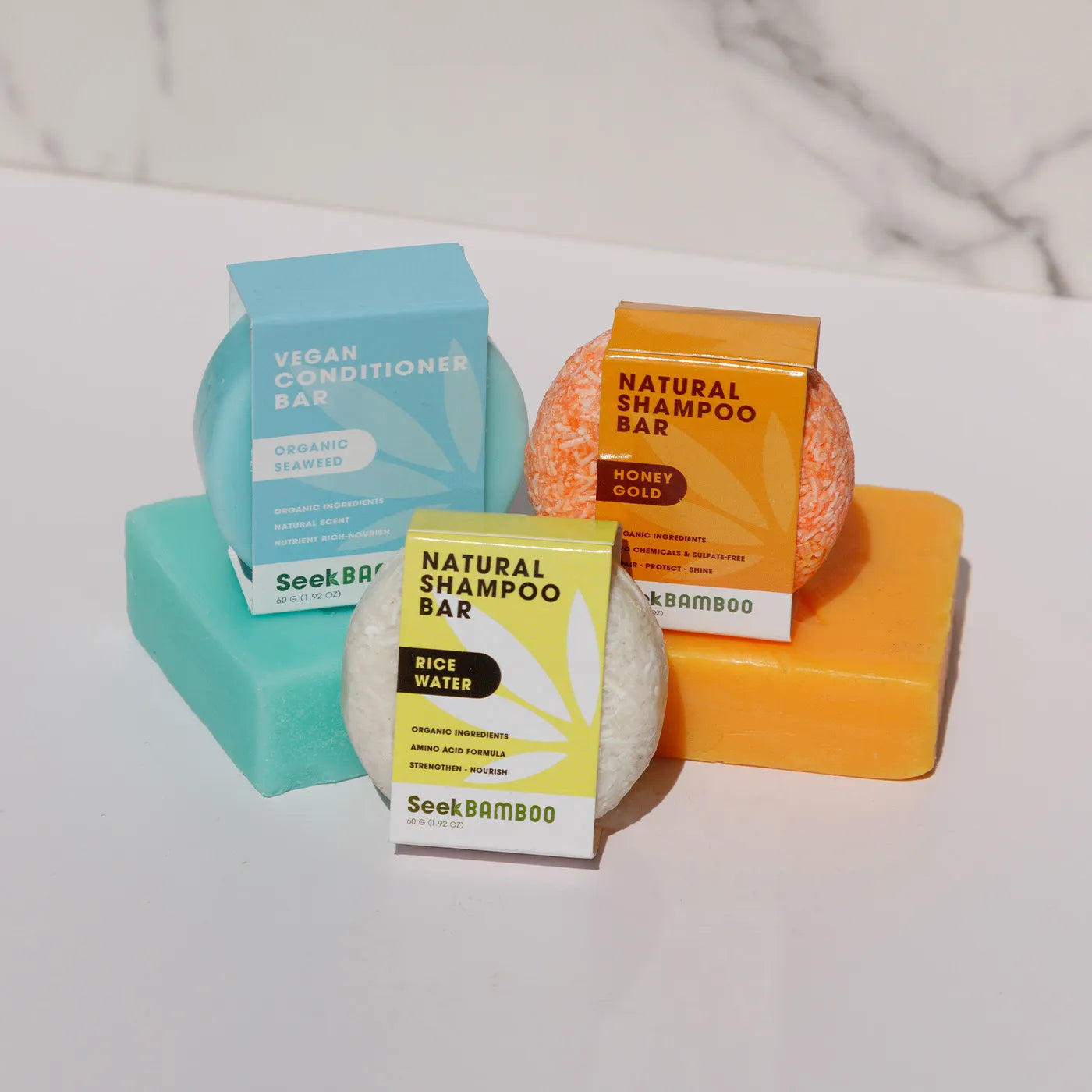 multiple shampoo bars stacked on top of their matching soap bar