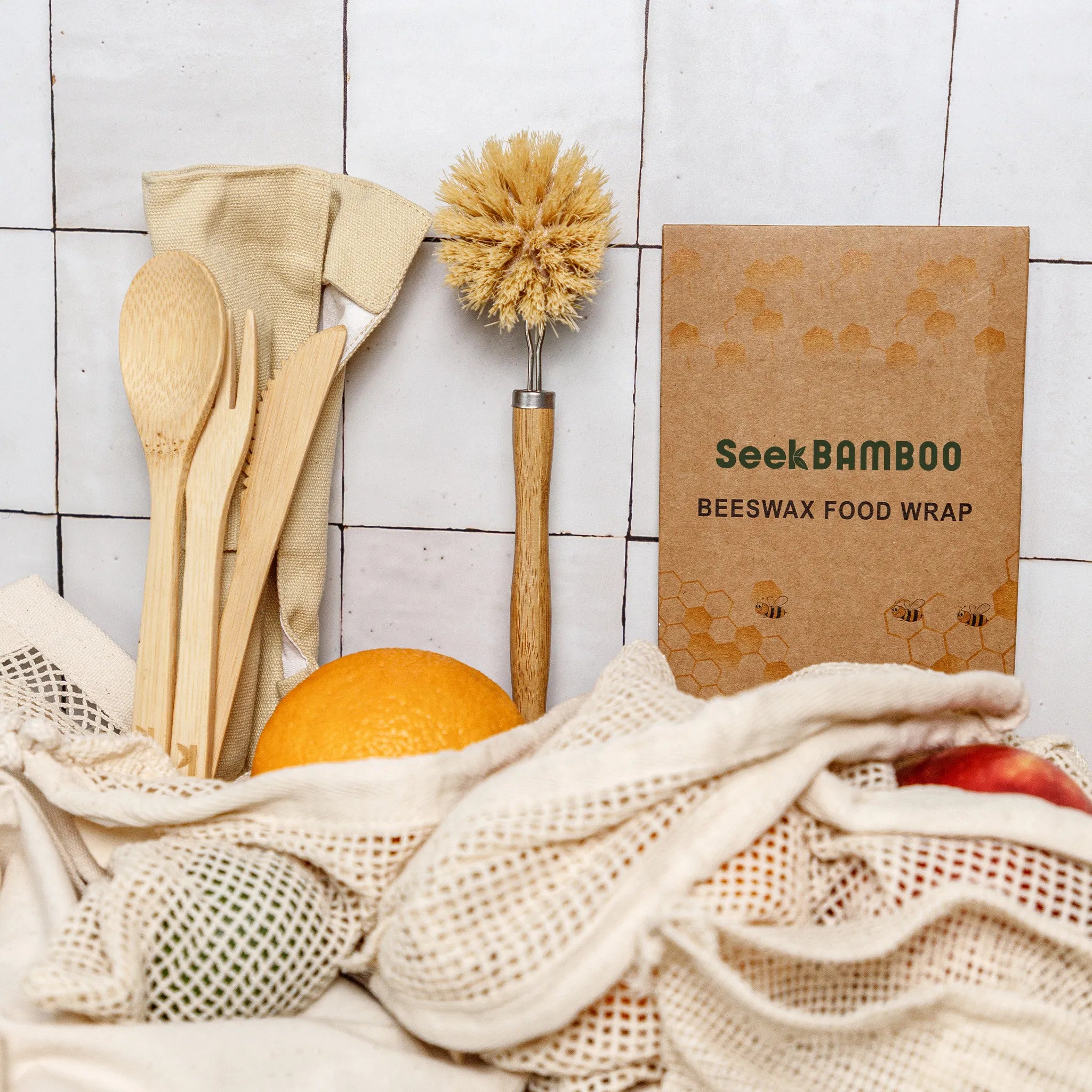 Beeswax food wrap with wooden utensils and fruits on a tiled background