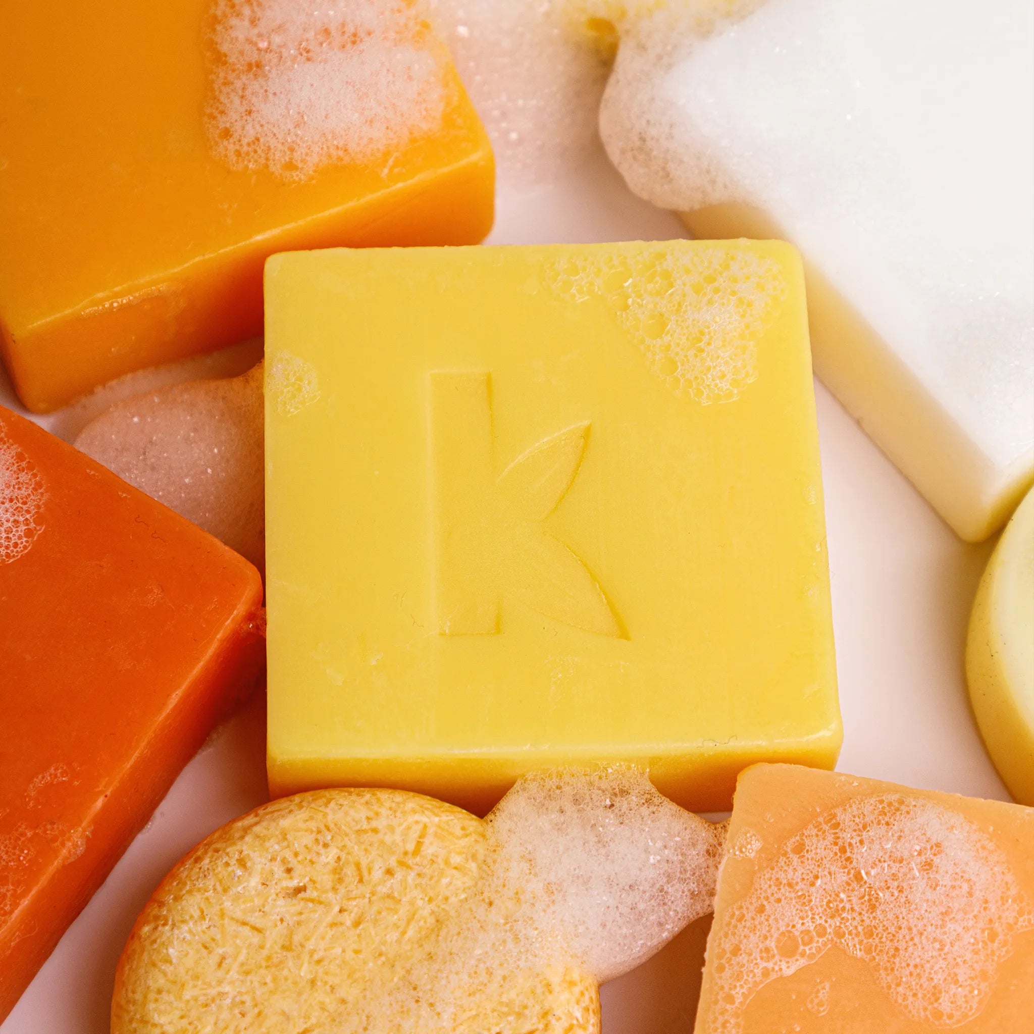 focus on the turmeric soap next to a kojic acid soap bar