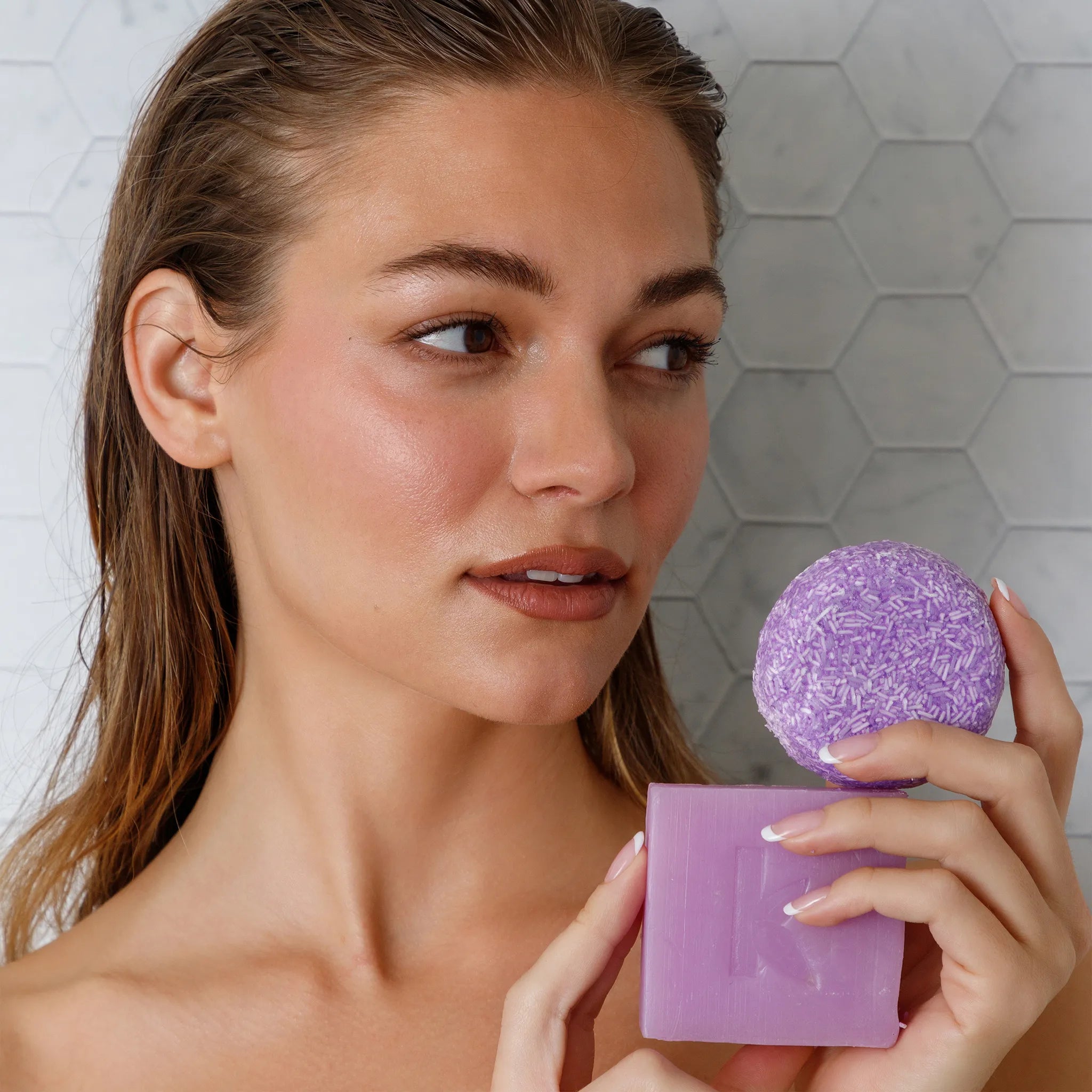 holding solid lavender shampoo and soap