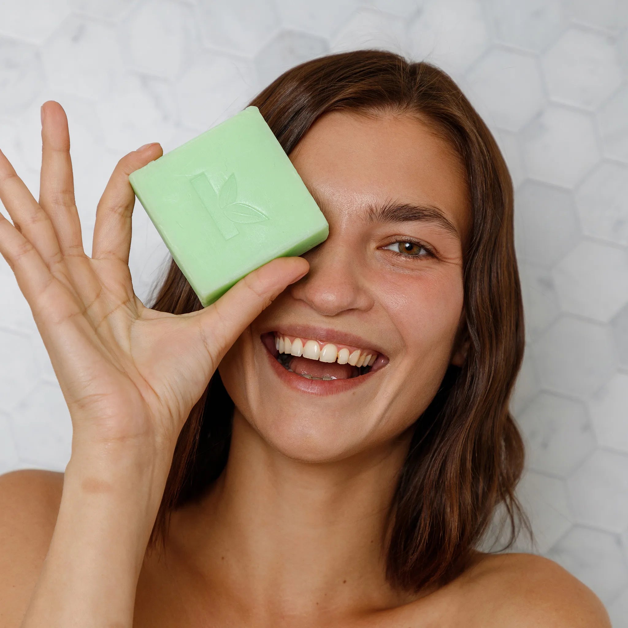 soap olive oil resting over a womans face