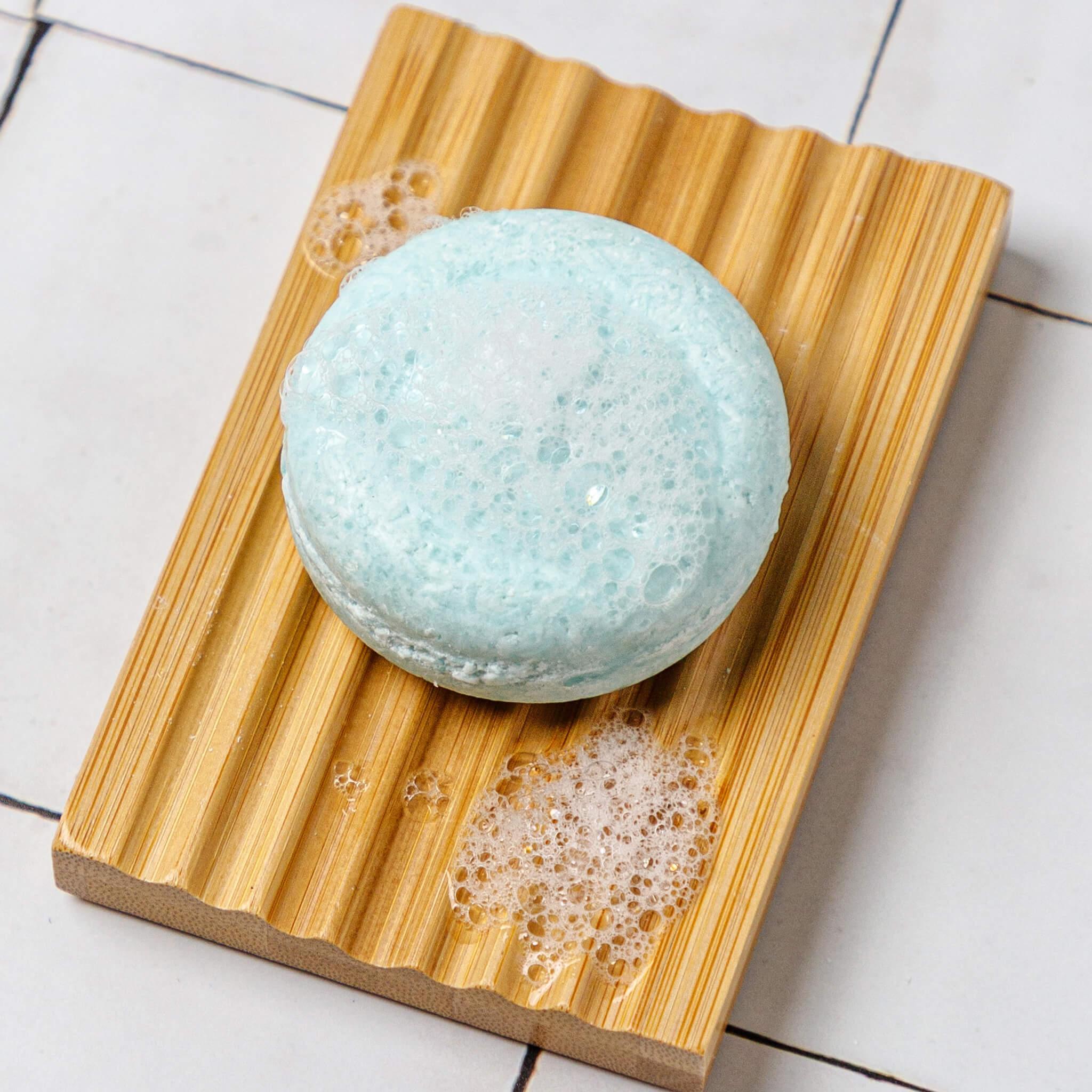seaweed shampoo on a bamboo soap dish