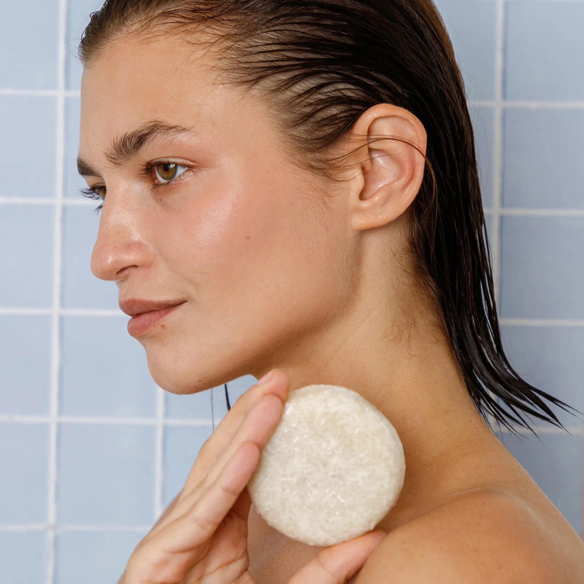 rice shampoo bar being held up by a woman
