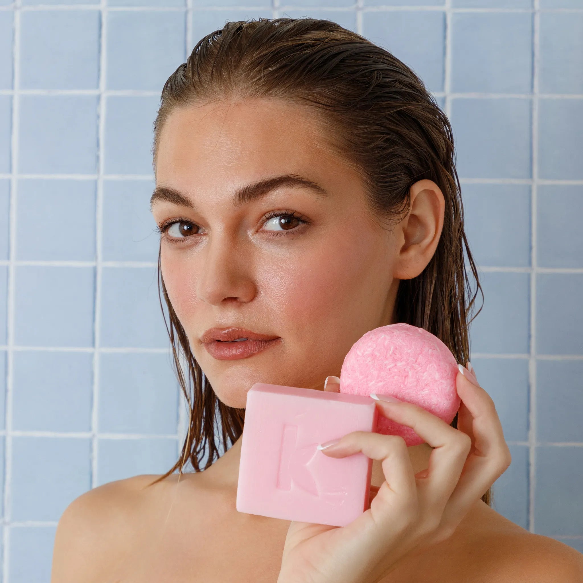 rose soap and shampoo held