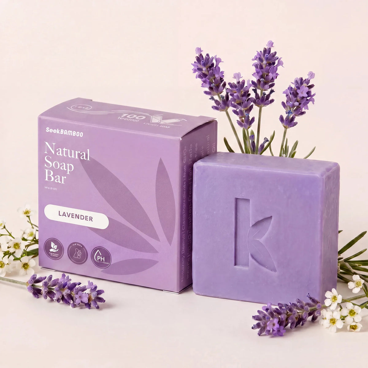 lavender oil soap bar with packaging and lavender flowers on a light background