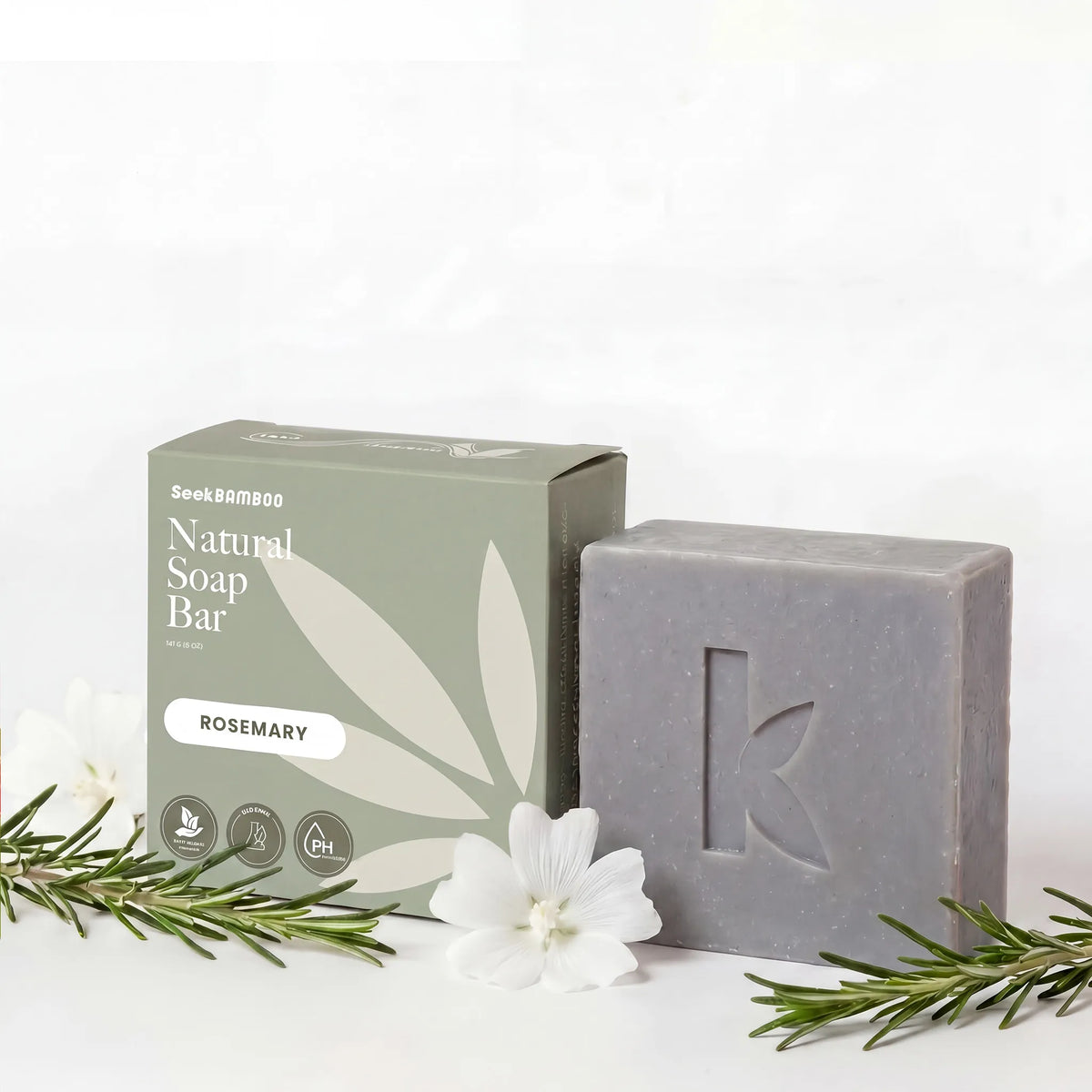 rosemary oil soap bar with next its branded box labeled on a white background.