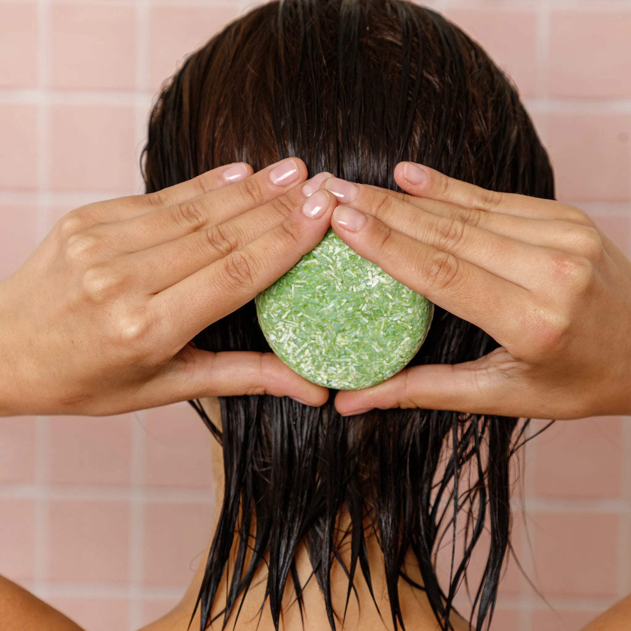 shampoo bar held on the back of the hair with tea tree oil