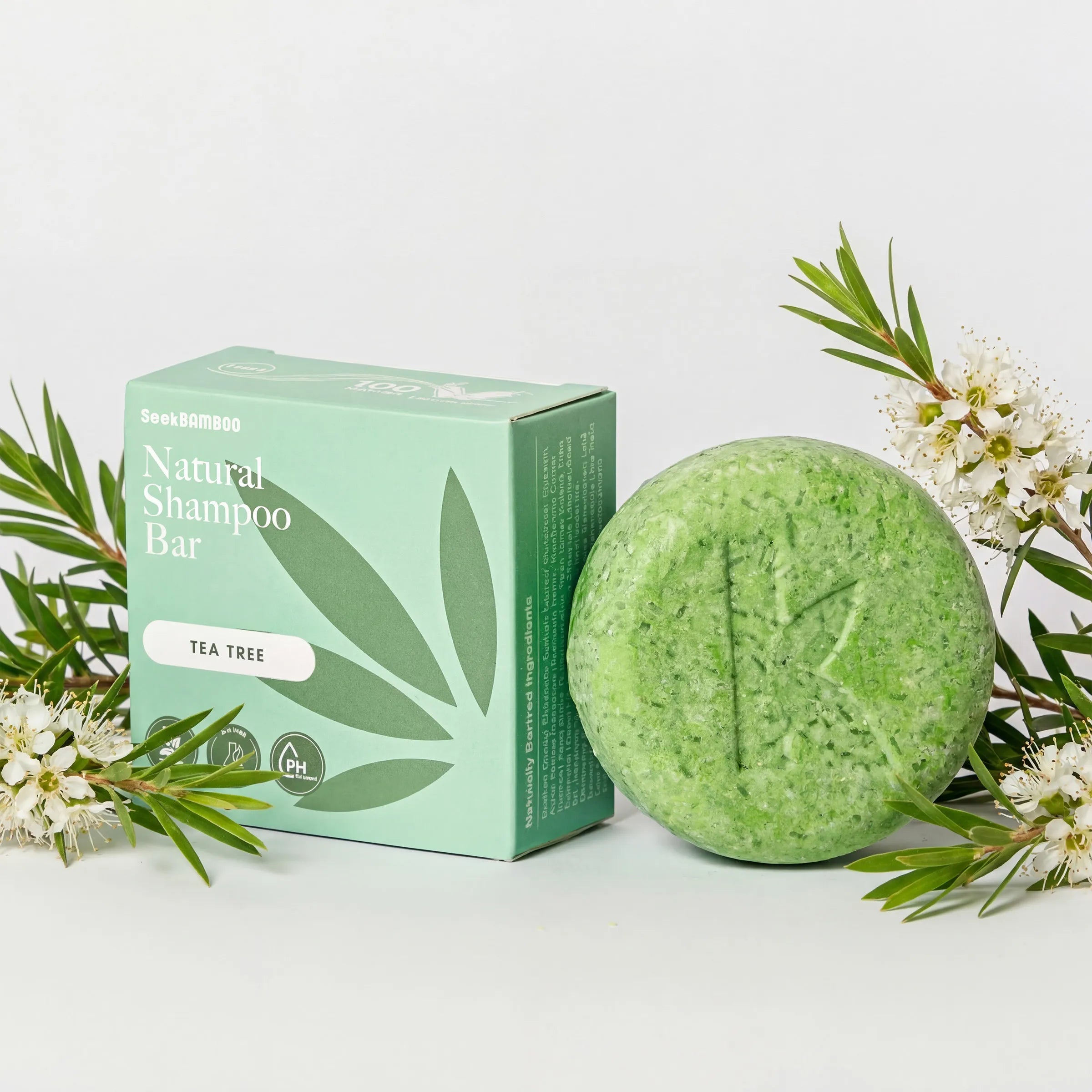 natural curly hair shampoo bar that is tea tree scented with packaging on a white background