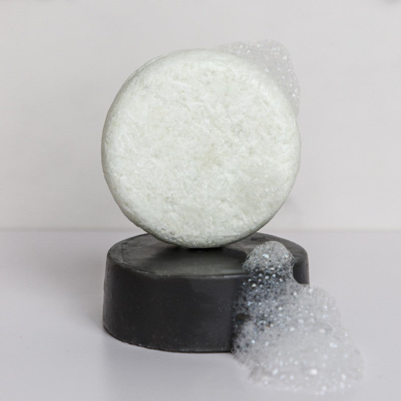 rosemary shampoo stacked on a romseary conditioner bar