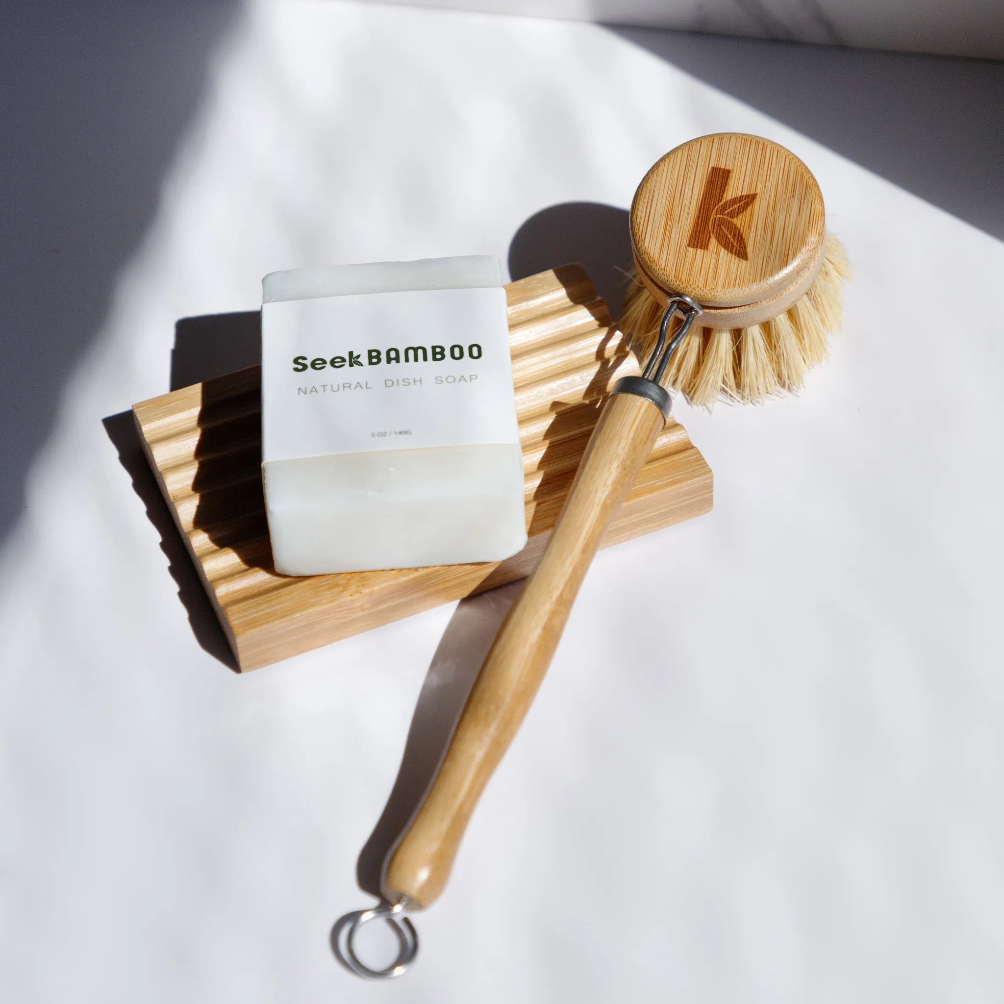 a bamboo dish brush sitting on a bamboo soap dish from seek bamboo