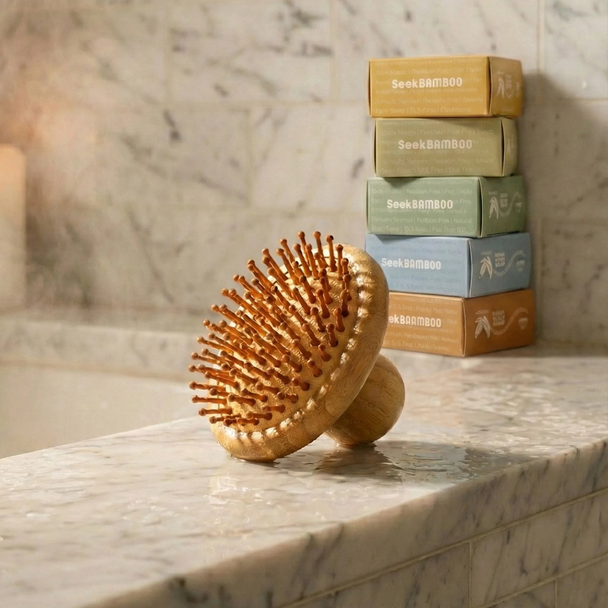 Wooden hairbrush on a marble surface with stacked boxes labeled 'SeekBamboo' in the background.