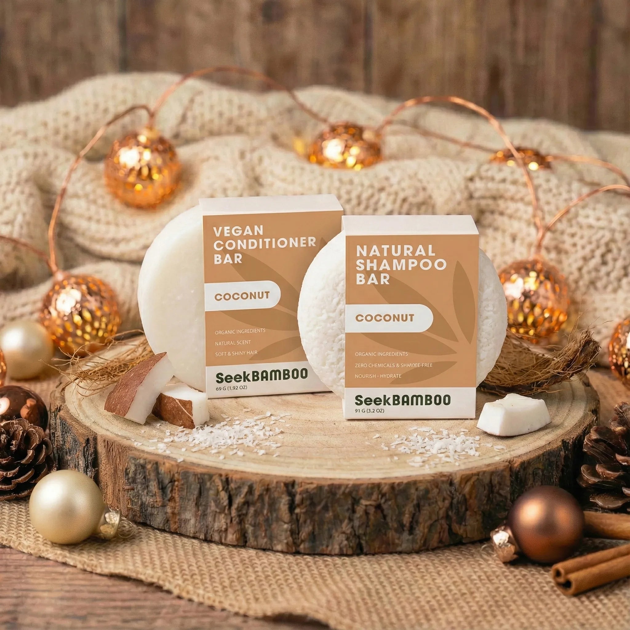 SeekBamboo coconut shampoo and conditioner bars on a wooden surface with decorative lights and ornaments.