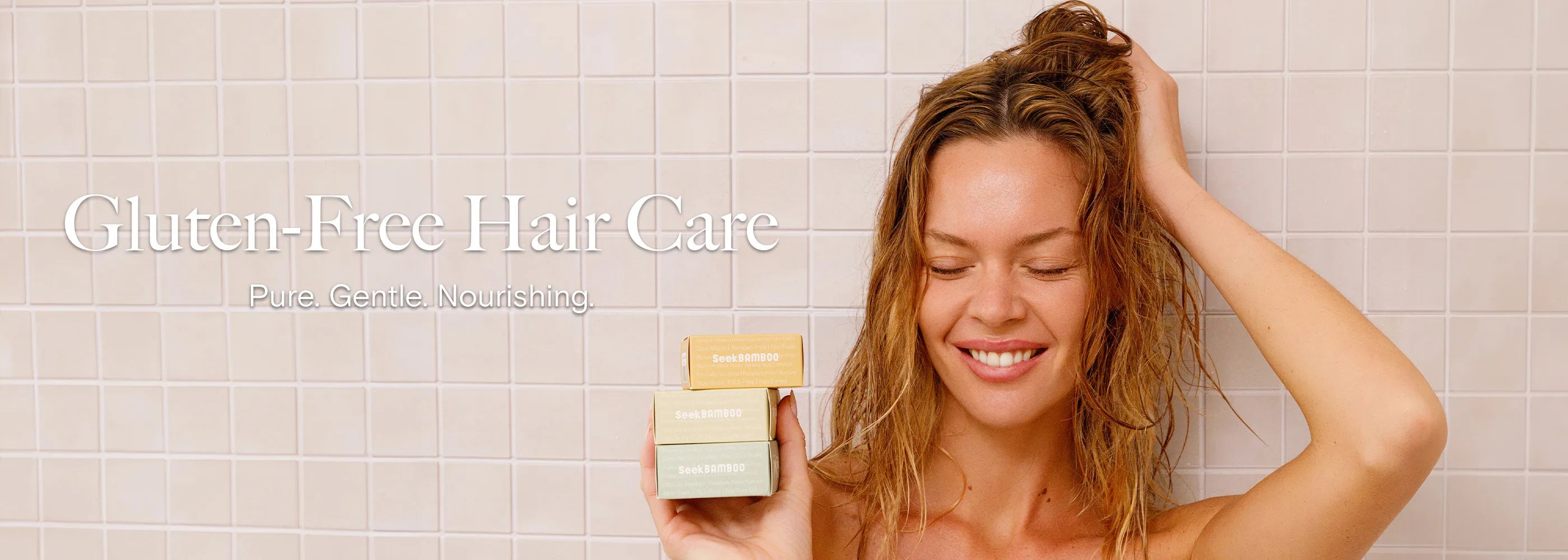 woman holding gluten free hair shampoo boxes.