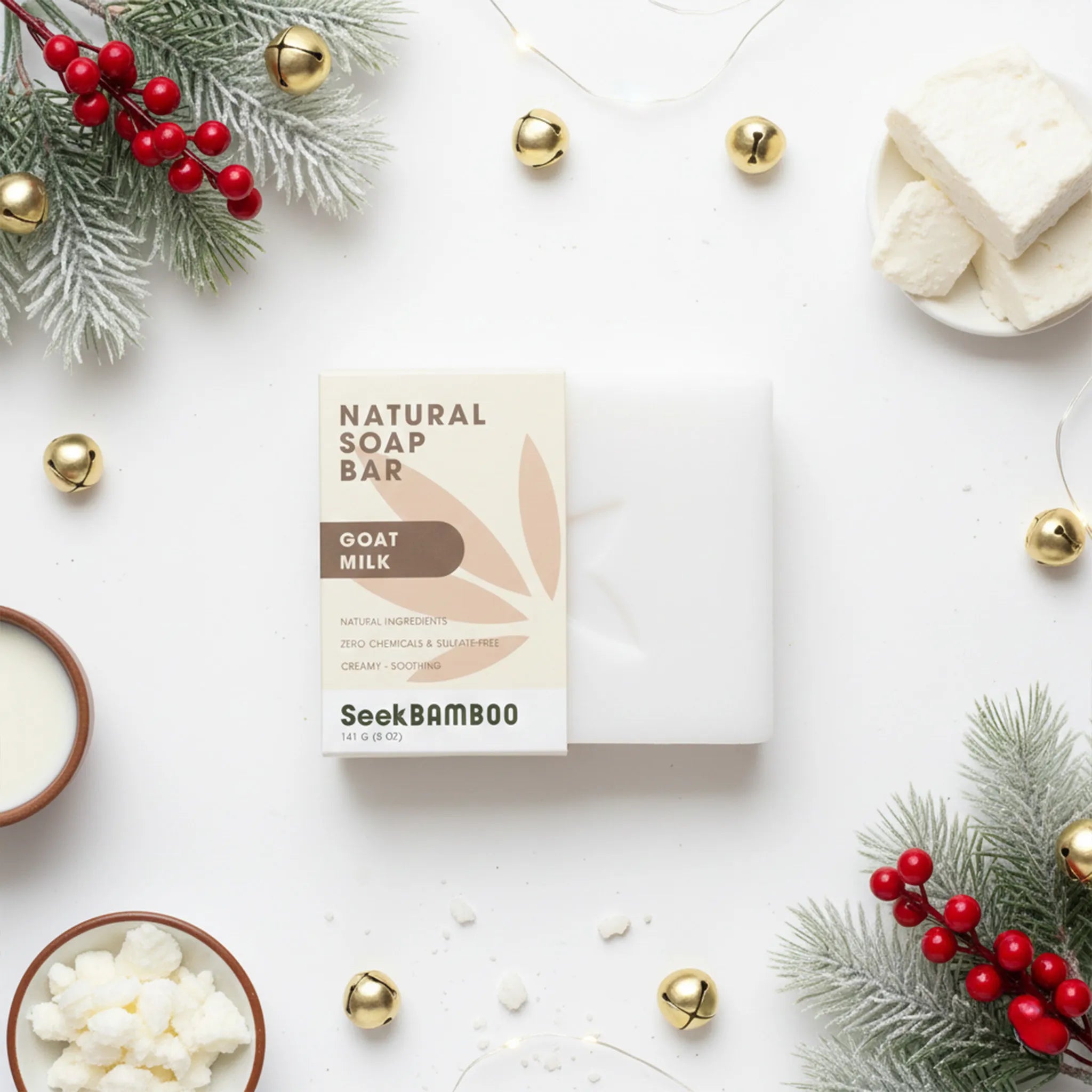 Box of SeekBamboo goat milk soap bar surrounded by decorative elements on a white surface