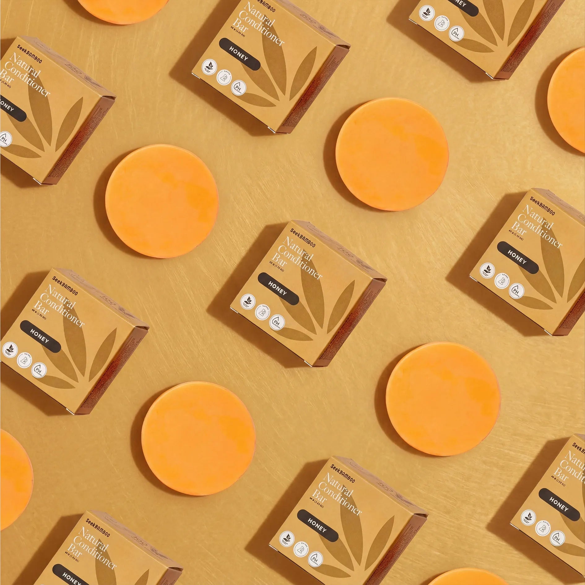 Pattern of honey conditioner bars and seek bamboo packaging on a yellow background