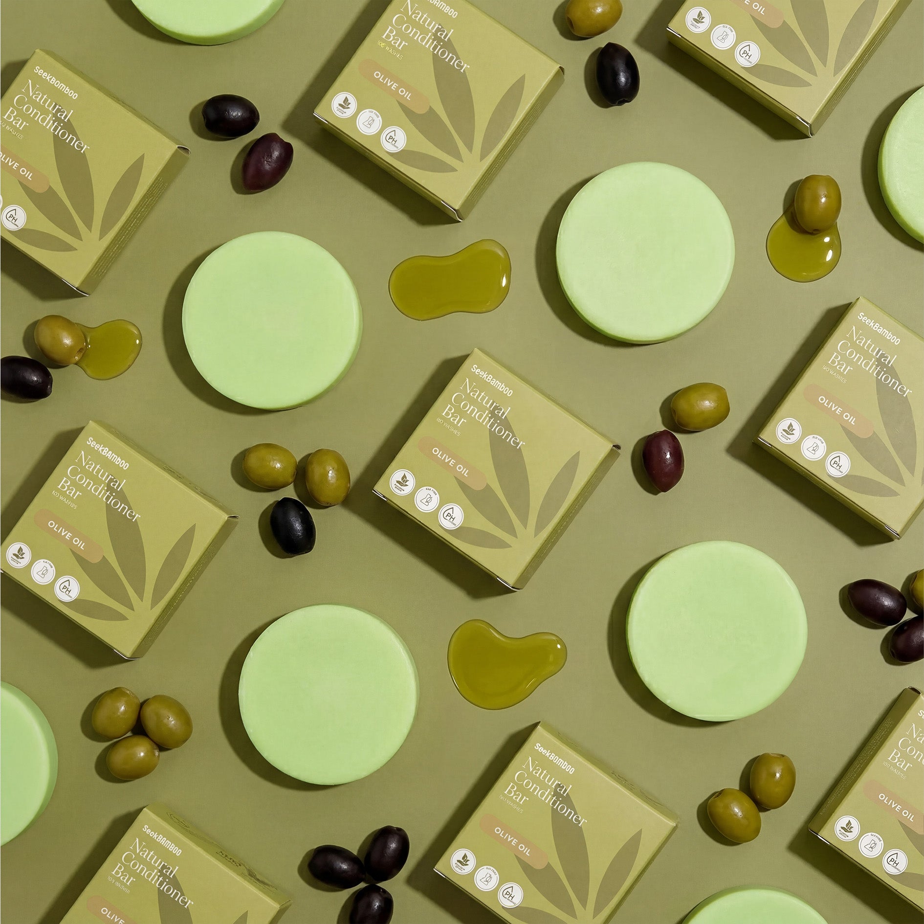Olive Oil Conditioner bars and seek bamboo boxes on a green background with olives.