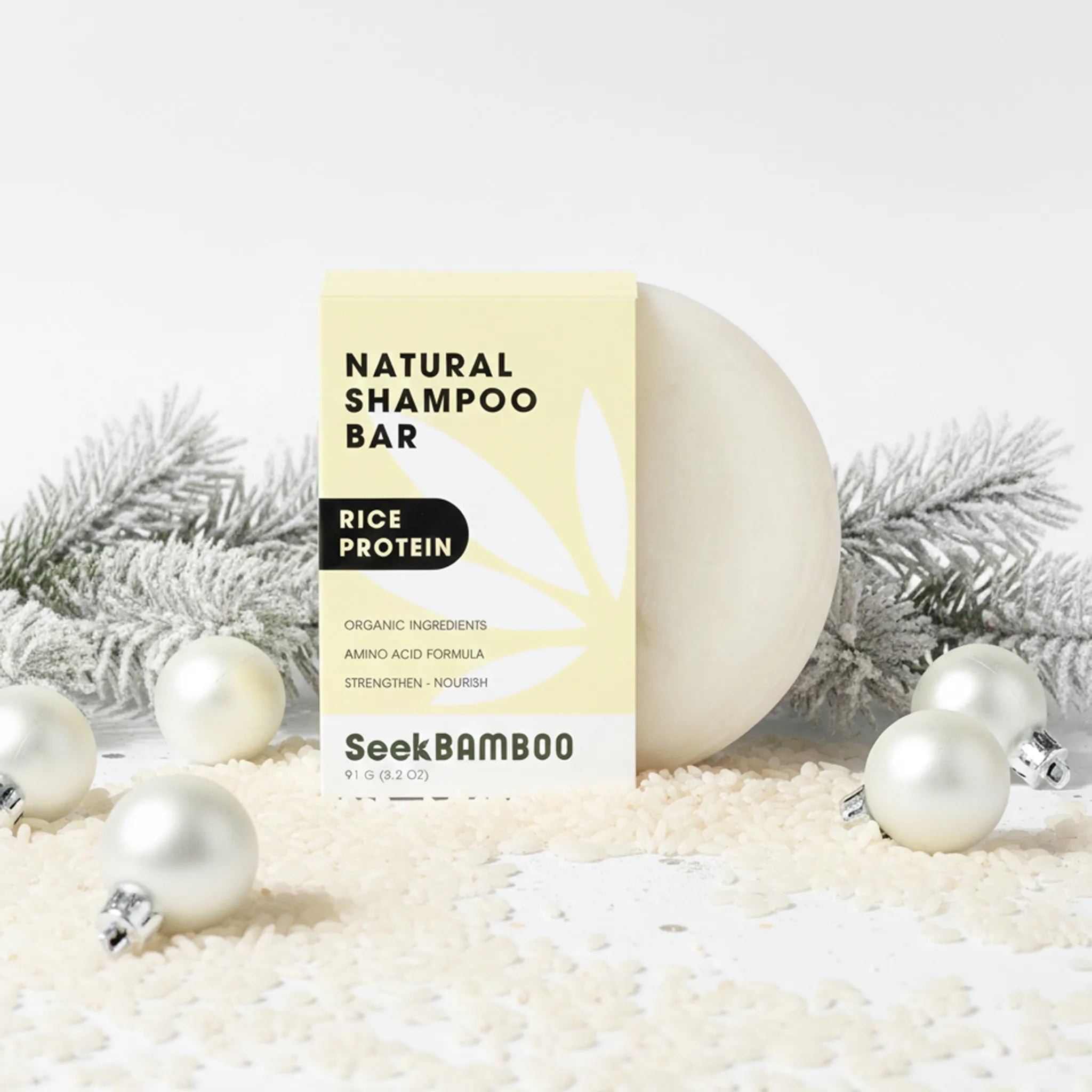 Natural rice water shampoo bar with packaging labeled 'SeekBamboo' on a white background with decorative elements.