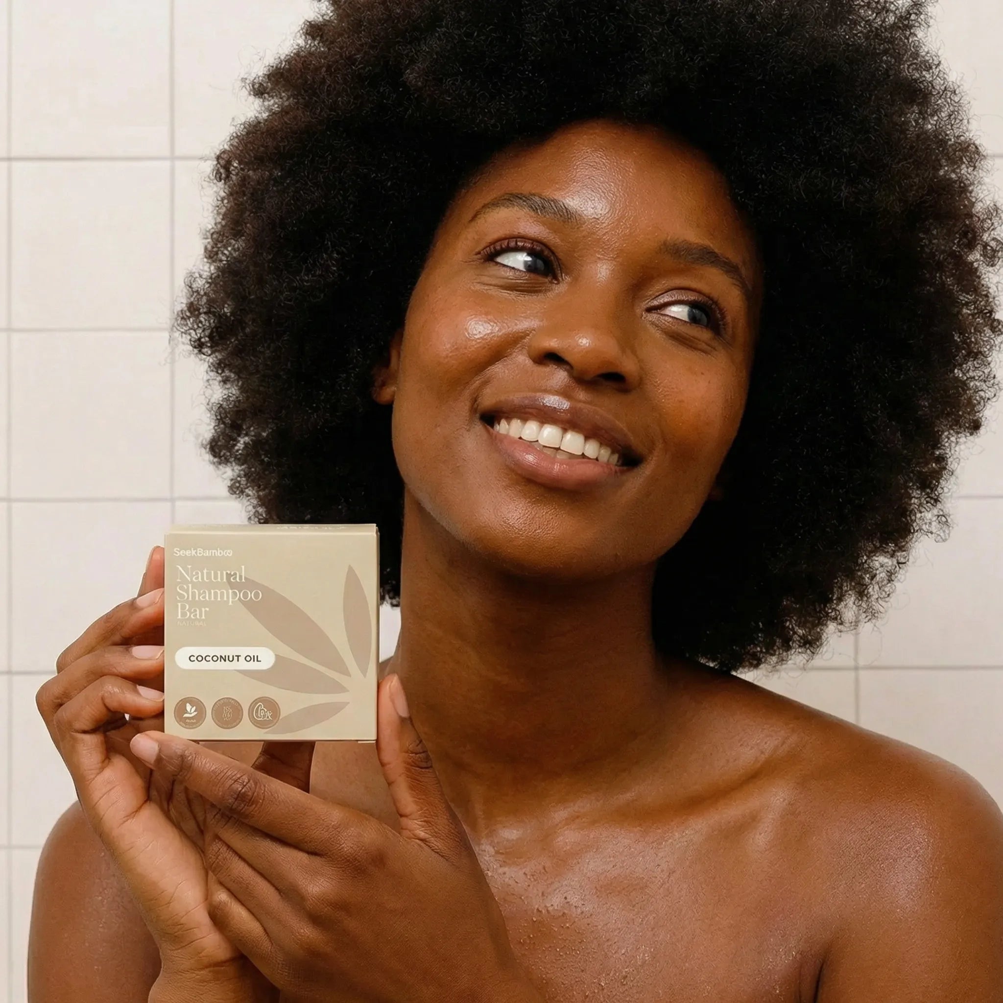 Woman holding coconut oil shampoo bar 