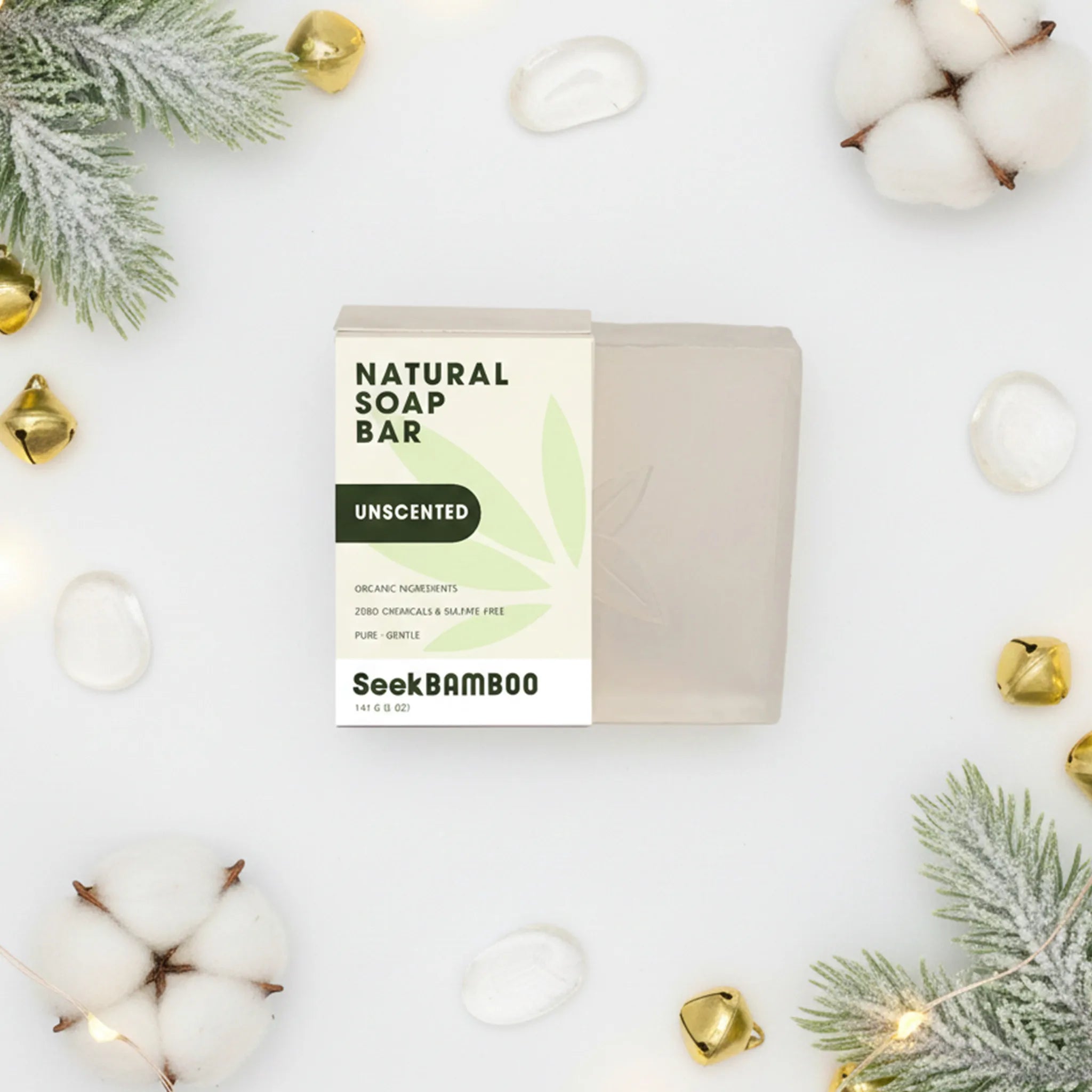 Natural soap bar with Seek Bamboo packaging on a white background with cotton and Christmas decorations.