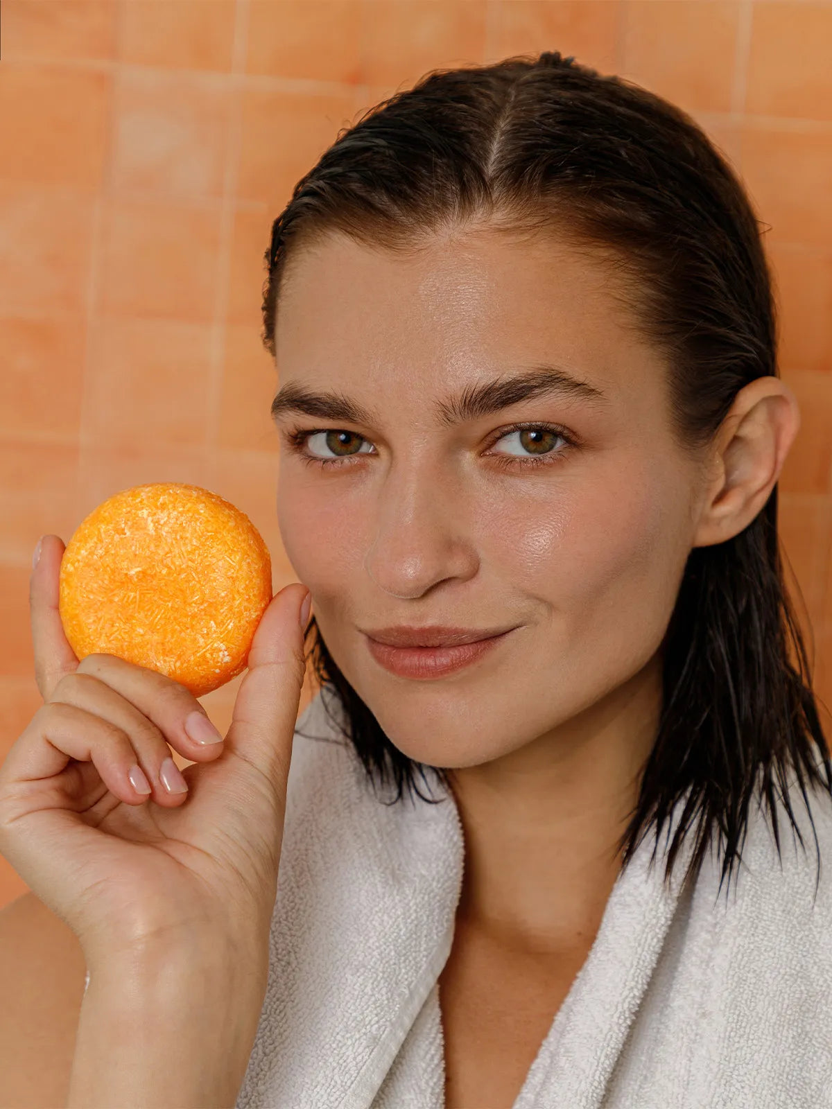 woman holding honey shampoo bar from seek bamboo