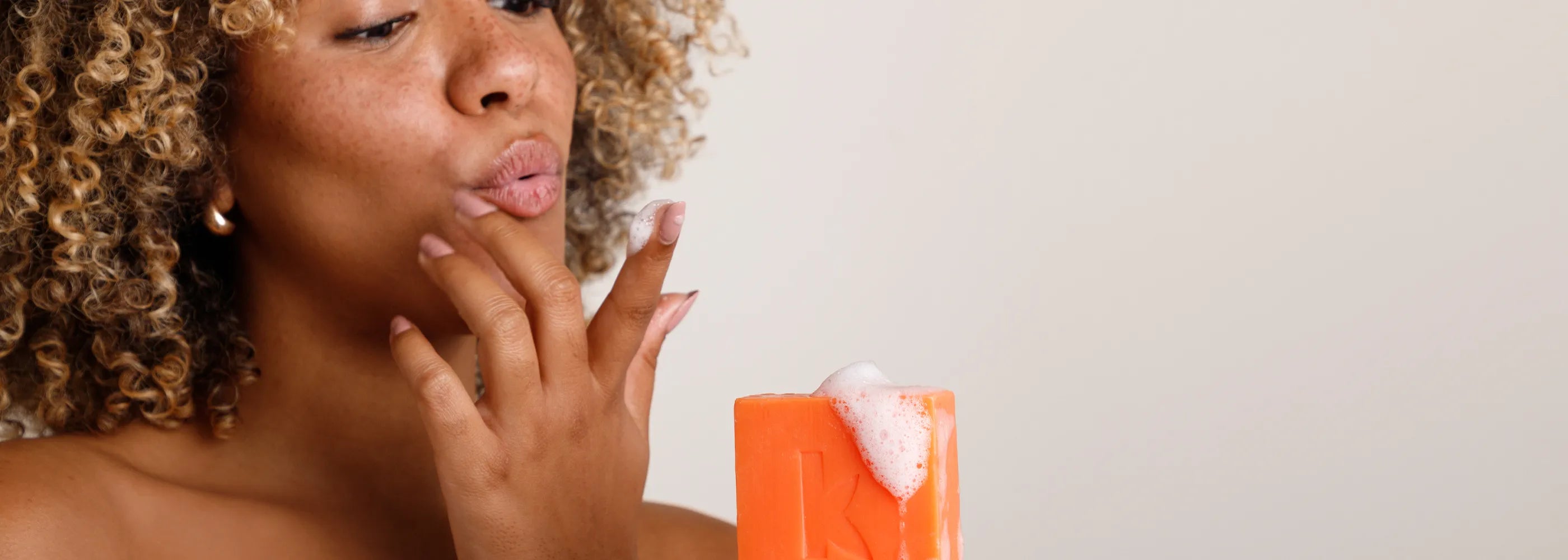 woman holding honey soap for a slide show photo of a blog about the benefits of honey soap