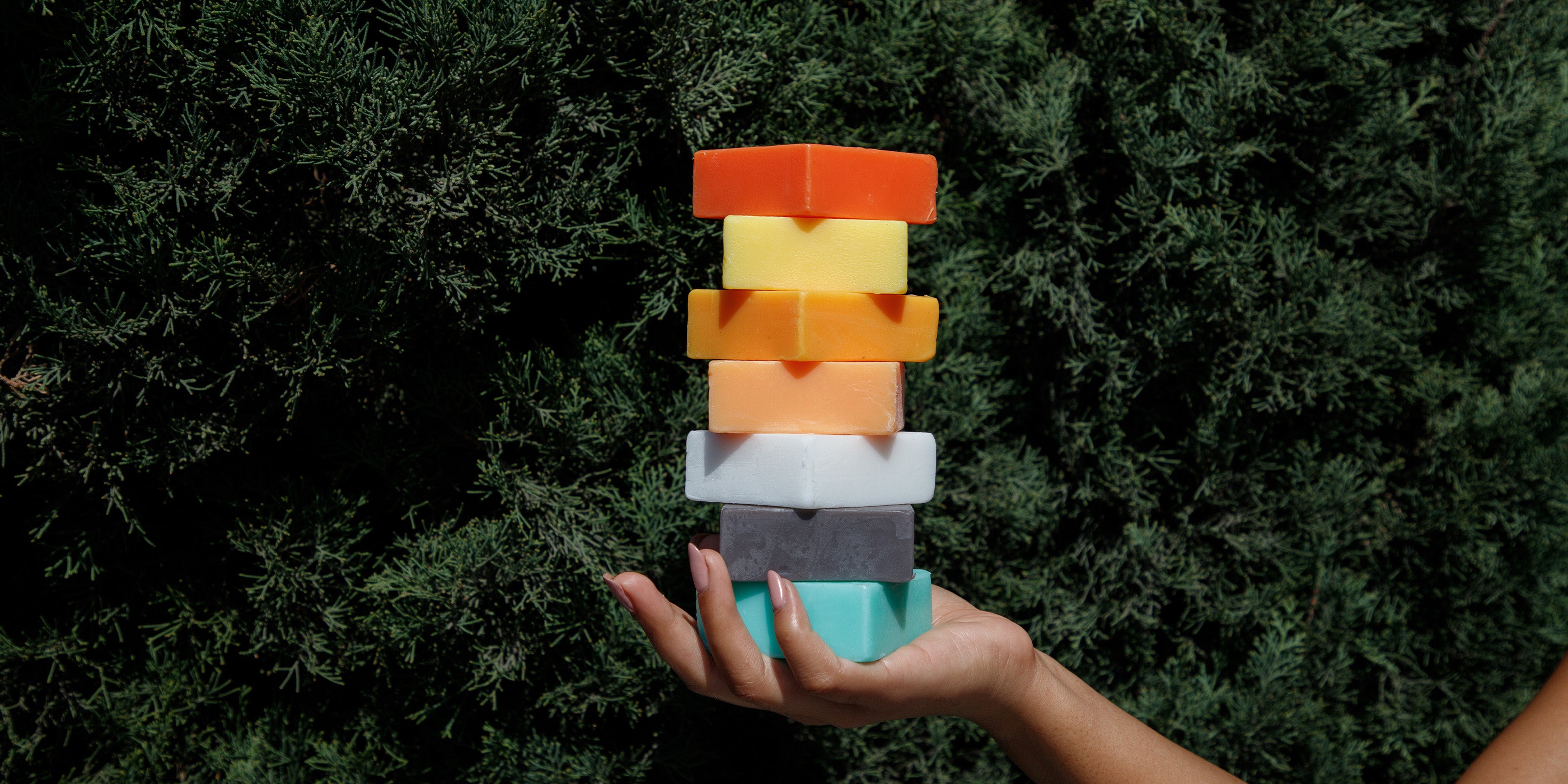 blog banner photo showing stack of natural soaps with a kojic acid soap at the top