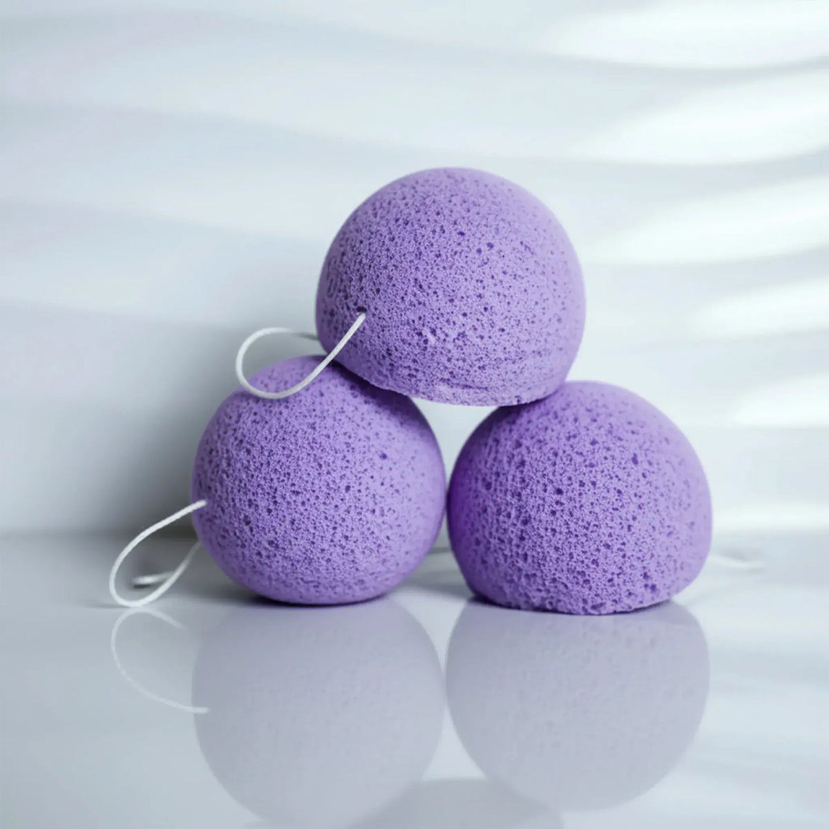 3 lavender konjac sponges stacked in a pyramid
