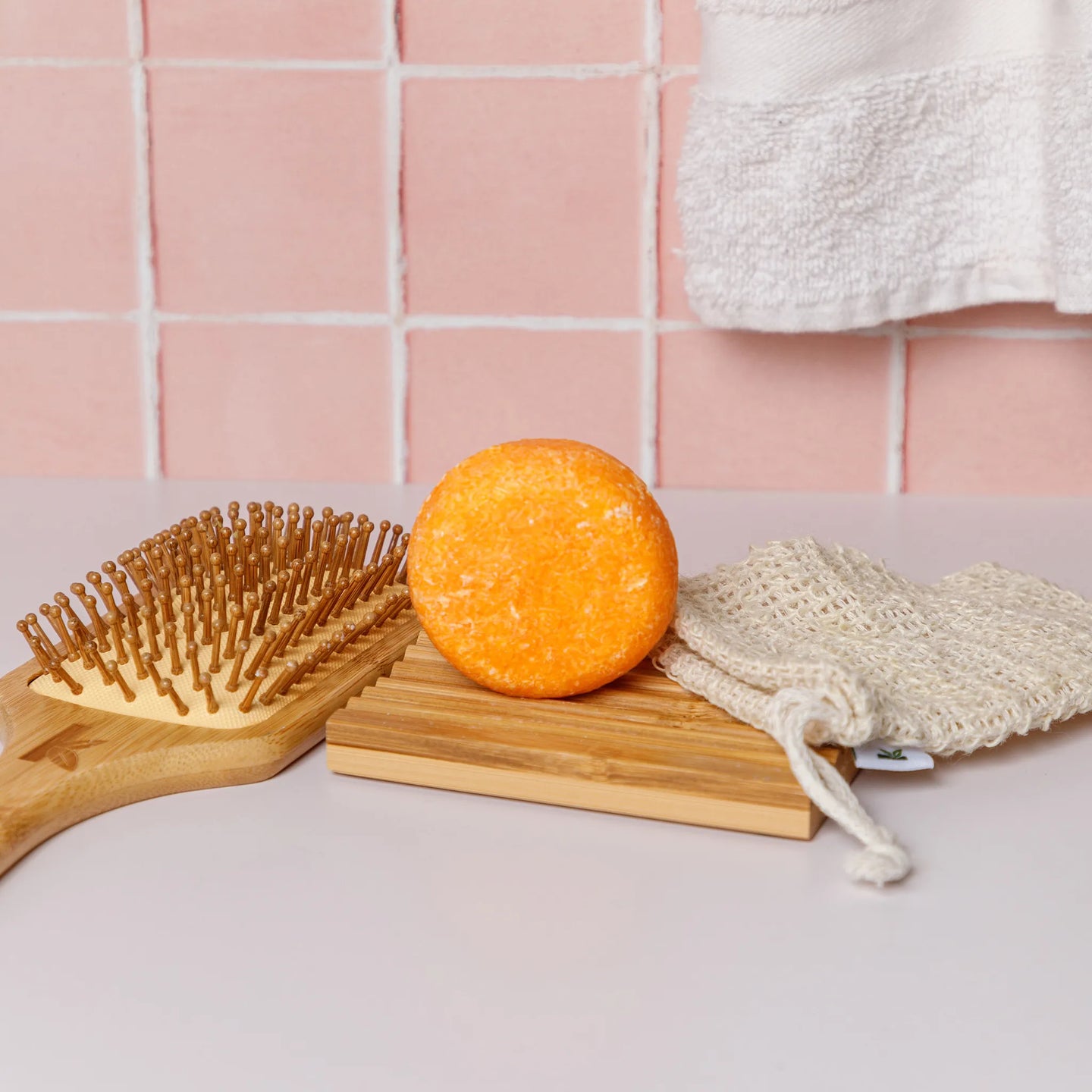honey shampoo standing up on a bamboo dish