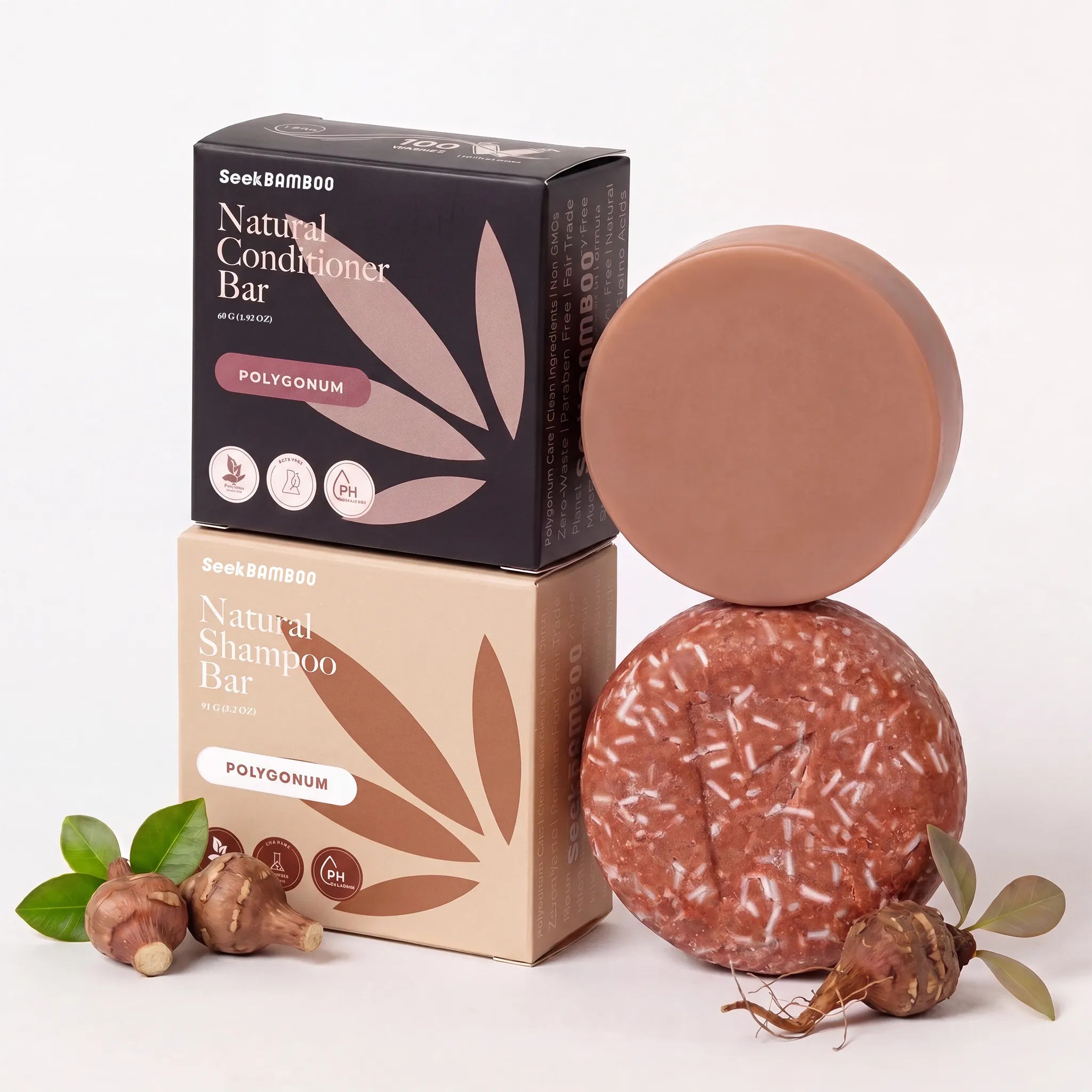 Two round gray hair natural shampoo and conditioner bars displayed with their polygonum boxes on a white background. 