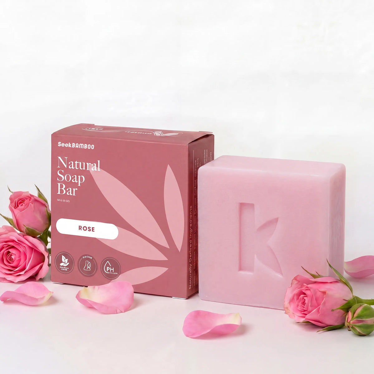 Rose natural soap bar with packaging and roses on a light background