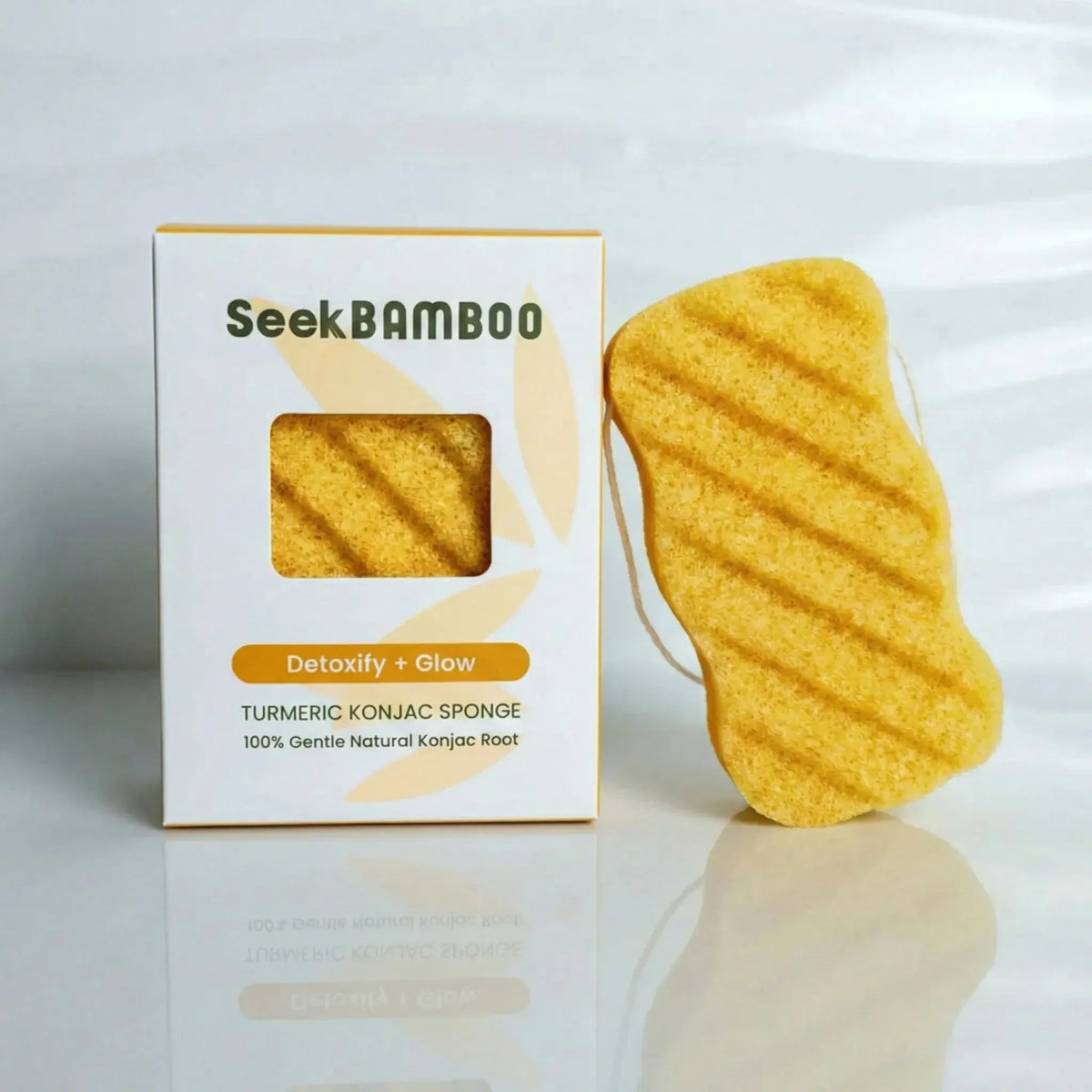 Turmeric konjac body sponge main product image of sponge leaning on product box for Seek Bamboo