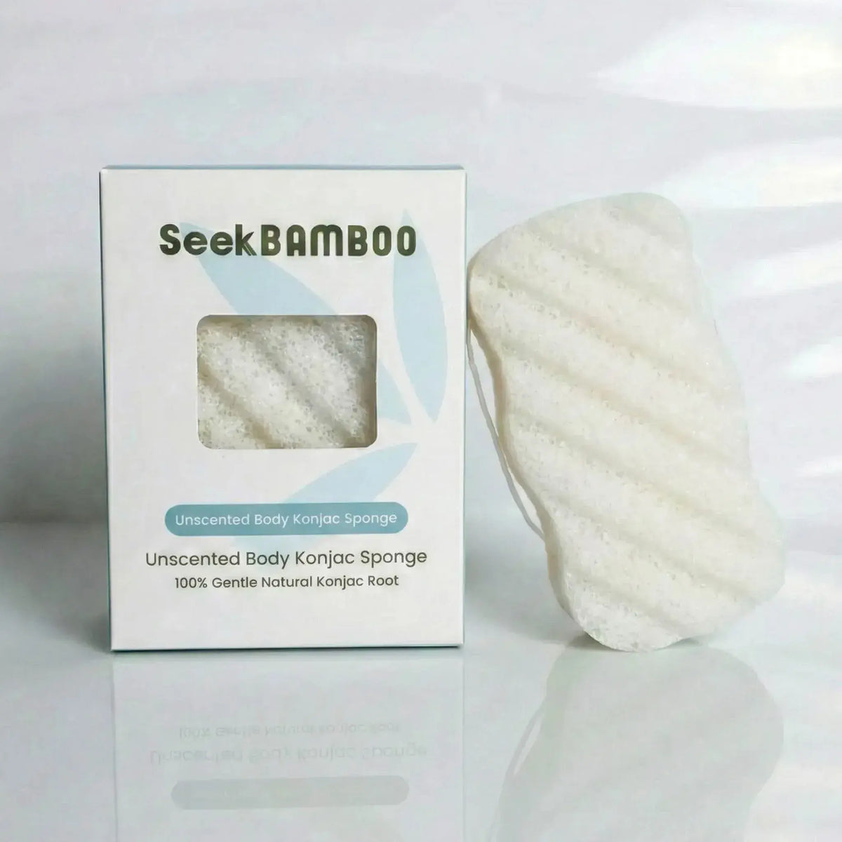 an unscented body sponge from konjac root leaning on its box on a white background