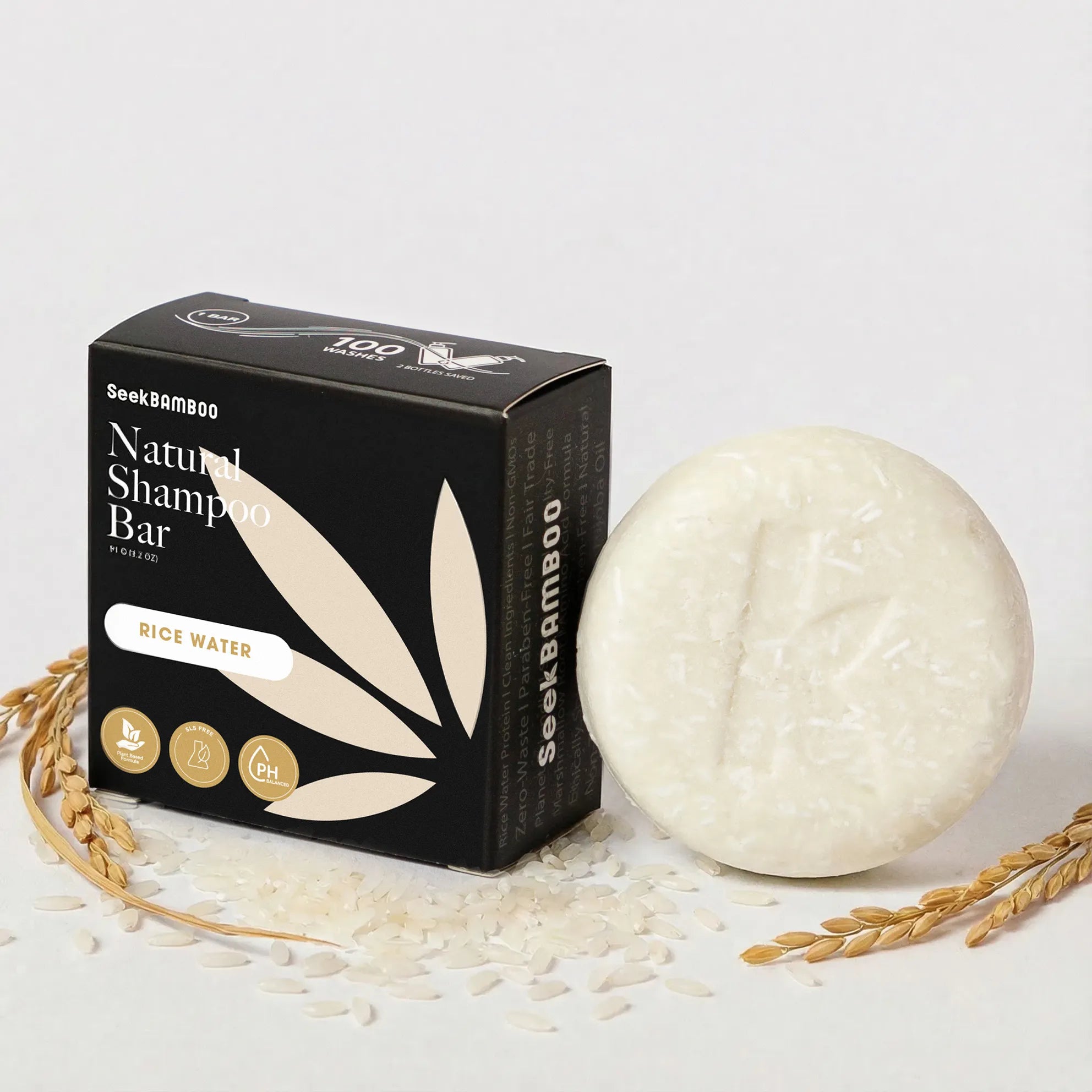 A solid shampoo for volume next to its black packaging box labeled as rice water shampoo bar for a main product image