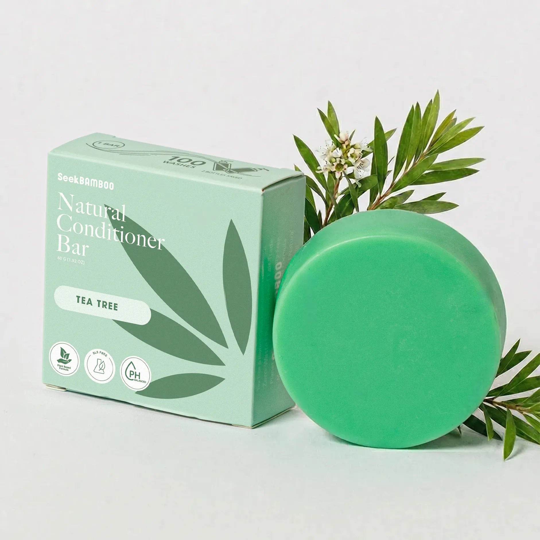 volumizing conditioner scented with tea tree oil with product packaging on a white background