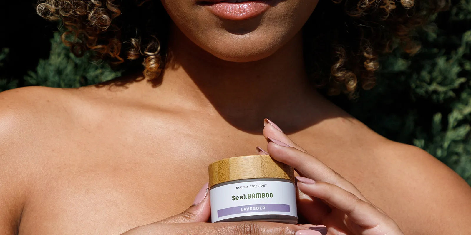 a woman showcasing a cream deodorant from seek bamboo