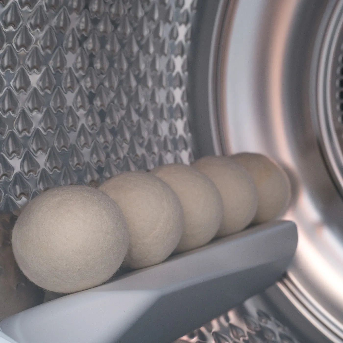 dryer balls on a laundry machine as a blog image for what do dryer balls do