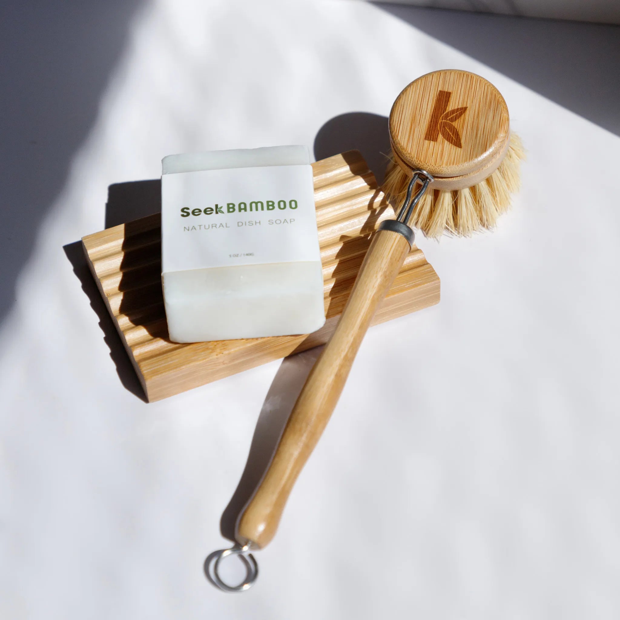 a bamboo dish brush sitting on a bamboo soap dish from seek bamboo